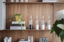 Open floating shelves in the kitchen coupled with minimal white cabinets