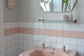 Pink pedestal sink in retro bathroom