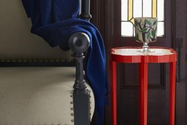 Red quatrefoil table in an entryway