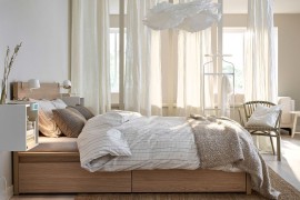 Relaxing bedroom with wall-mounted, beautiful bedside stands and white drapes