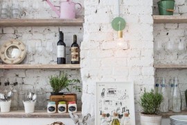 Rustic eclectic kitchen with a white brick wall