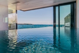 Sensational indoor infinity pool seems to merge with the Adriatic Sea outside!