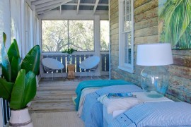 Sleeping porch with bright bedding