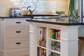 Small shelves built into kitchen island for books and accessories