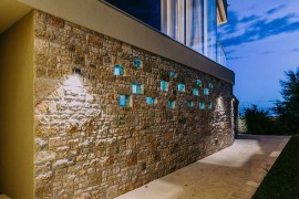 Stone wall around the house defines its entrance