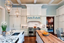Striped wallpaper creates a soothing backdrop for the spacious traditional kitchen