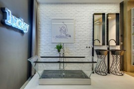 Transparent bathtub and bright neon wall sign for the eclectic contemporary bath