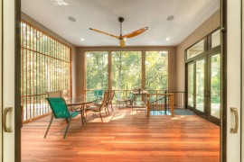 Treehouse sunroom with simple, understated decor [Design: Sagatov Design-Build]