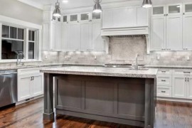 White granite in a white kitchen with metallic tones