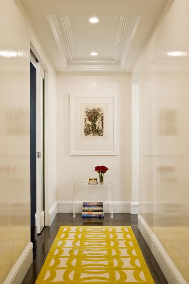 Yellow hallway rug on dark hardwood flooring