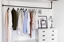 Minimalist open concept closet with white dressers