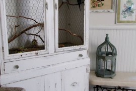 Armoire repurposed as a bird cage for real pet birds