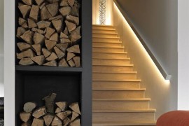 Basement stairway with LED light strip along railing