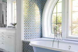Bathtub with rounded edges in a traditional powder room