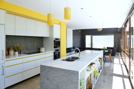 Beautiful midcentury modern kitchen with pops of yellow [Design: Klopper and Davis Architects]