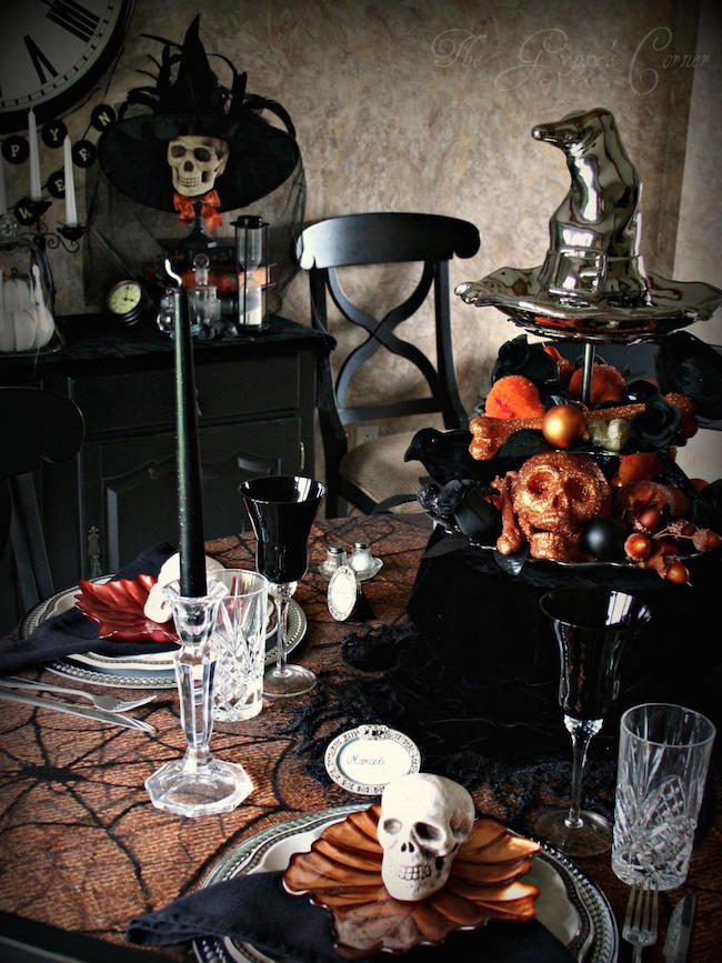 Black and orange Halloween table setting with lots of skulls