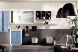 Blue floor stand base and wall hung cabinets create contemporary bathroom