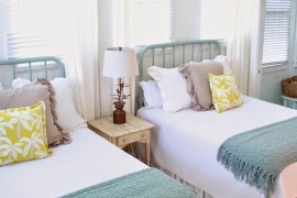 Bright and beach-themed twin beds in a guest room