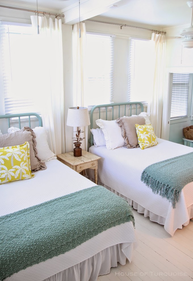 Bright and beach-themed twin beds in a guest room