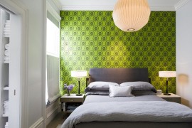 Bright wallpaper from Cole & Sons coupled with hints of gray in the bedroom