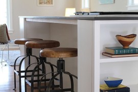 Built-in shelving for cookbooks complete the contemporary kitchen island [Design: Madison Modern Home]