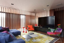 Colorful TV room in Brazilian home is part of a larger living space