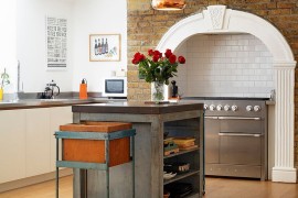 Copper pendants and central island steal the show in this kitchen [Design: Redesign London Limited]