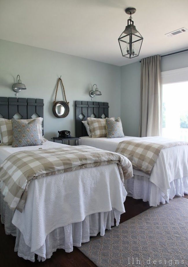 Country guest room with rustic wood head boards on twin beds