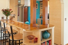 Craftsman style kitchen island with breakfast bar and open shelving at the end [Design: Celeste Lewis Architecture]