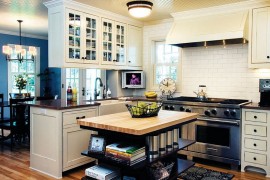 Custom built kitchen island in cherry wood stained with open shelves
