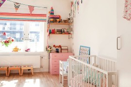 Decor and accessories bring color into this Scandinavian nursery