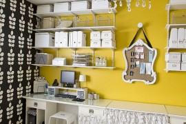 Fabulous wall shelves and yellow accent wall enliven the cool home office