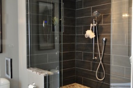 Gorgeous black tiled shower with built-in bench