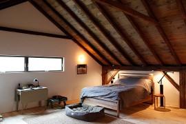 Gorgeous rustic bedroom design on the top level of the barn home