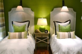 Green guest room with matching accent pillows for twin beds
