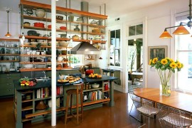 Industrial kitchen with ceiling-hung shelves and an island with open shelves as well!