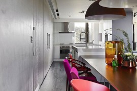 Kitchen counter seems to extend into the dining room visually