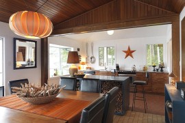 Kitchen island used as firewood stacker in this beach style home