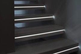LED light strips positioned in the middle of each step