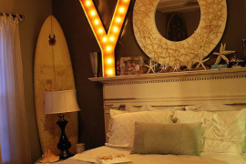 Marquee letter placed over the bed in a bedroom