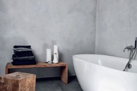 Minimalist bathroom with rustic wood bench and stool