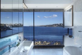 Modern bathroom with a rocky sea view