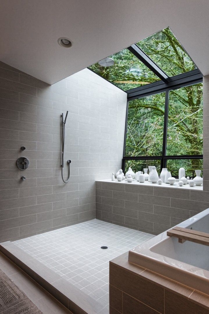 Modern bathroom with a vase collection and a view of the trees