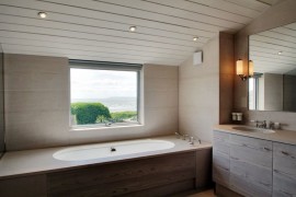 Modern bathtub with a view of the beach