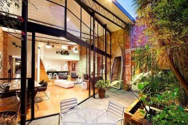 Open glass wall for the warehouse home brings in ample natural ventilation