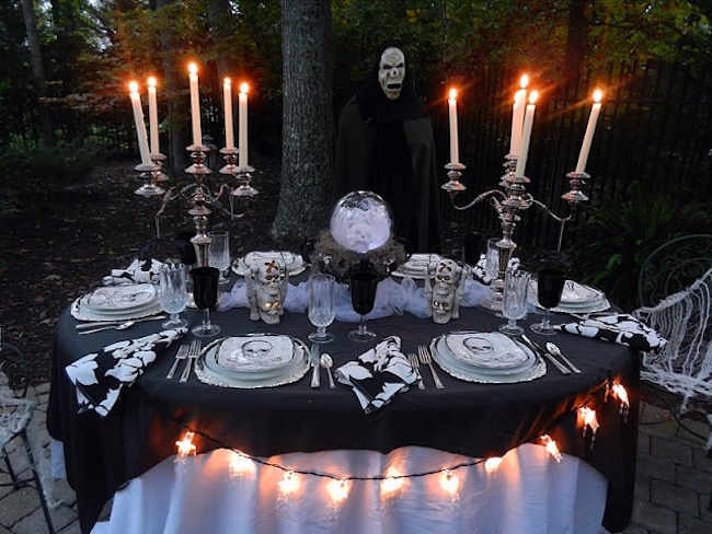 Outdoor Halloween table setting with large candlesticks