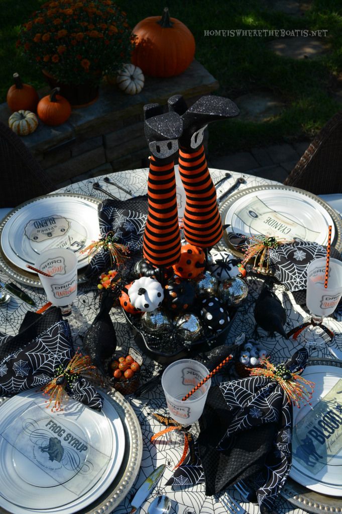 Outdoor Halloween table setting with witch's legs centerpeice