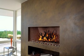 Plastered wall with sleek, contemporary fireplace for the beach style living room