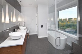 Powder room with a round tub and a view