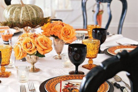 Romantic Halloween table setting with orange roses